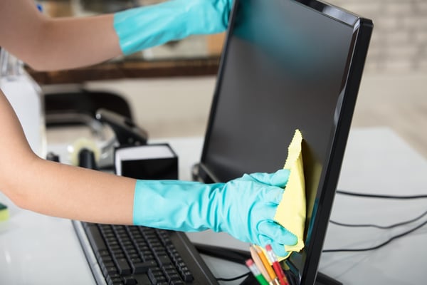 A cleaning professional creates a clean workspace.