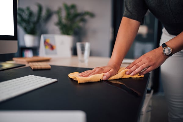 A man creates a clean workspace.