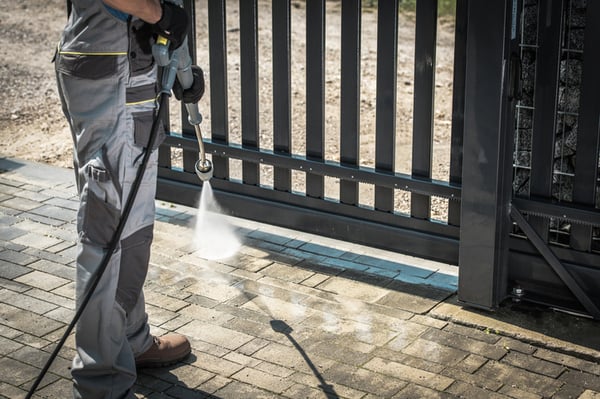 An ICC employee performs commercial power washing services.