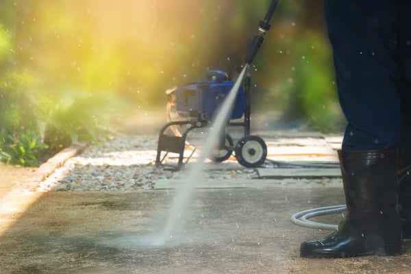 An ICC worker performs commercial power washing services.
