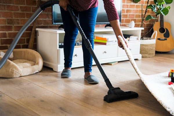 A woman vacuuming the floor