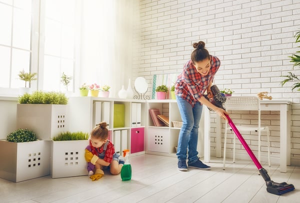 A mother and daughter clean their home.