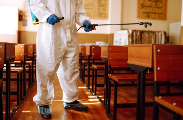 A worker performs school disinfecting