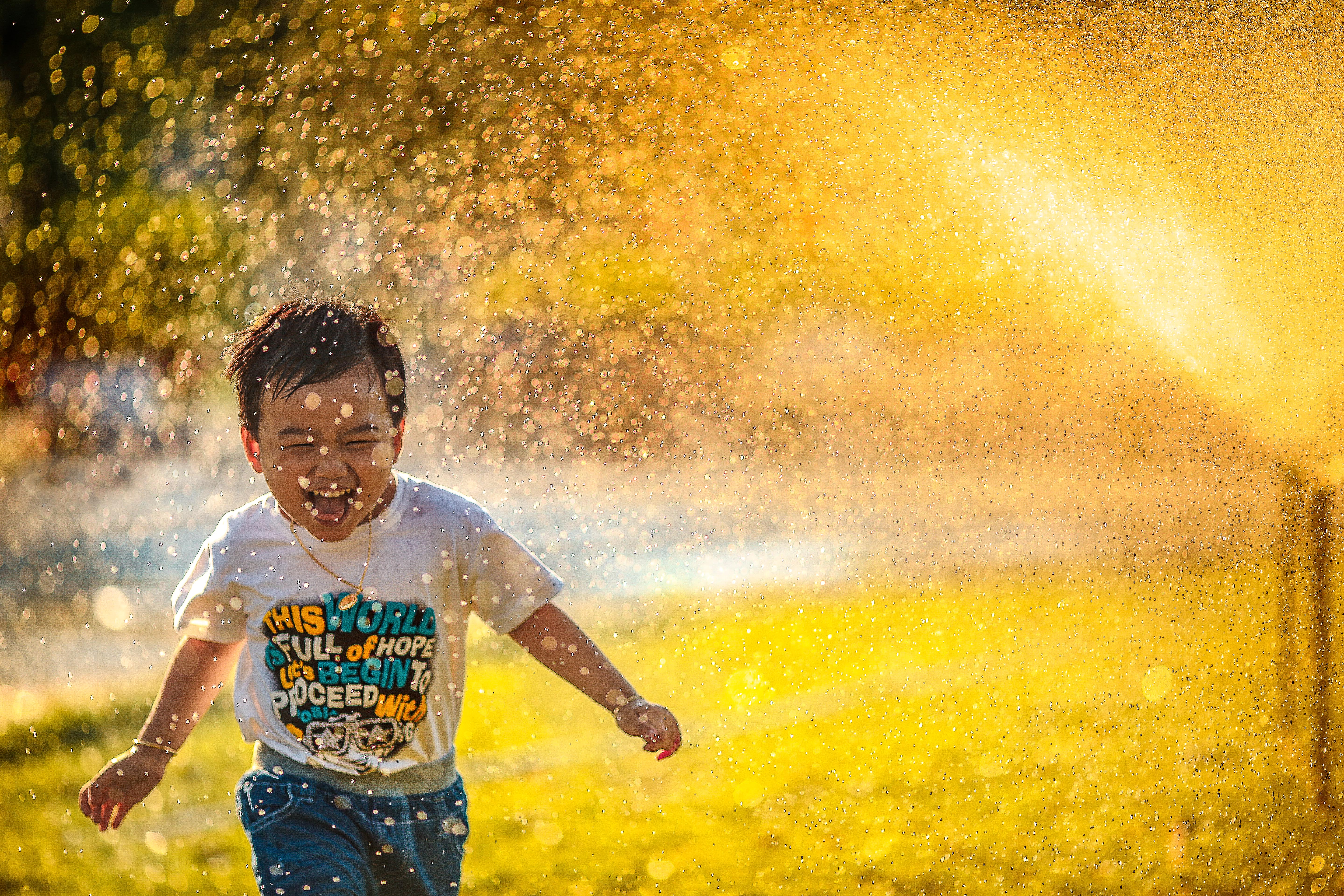 Summer Cleaning - Boy Running Through Sprinkler